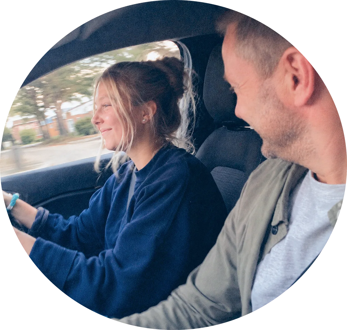 A learner driver at the wheel with a supervising driver alongside